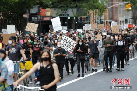 当地时间6月1日，纽约民众在曼哈顿街道游行抗议警察暴力执法。5月24日，在美国明尼苏达州明尼阿波利斯市，非裔美国人乔治·弗洛伊德因警察在执法过程中涉嫌动作失当而身亡。此事件在全美引发示威浪潮。中新社记者 廖攀 摄